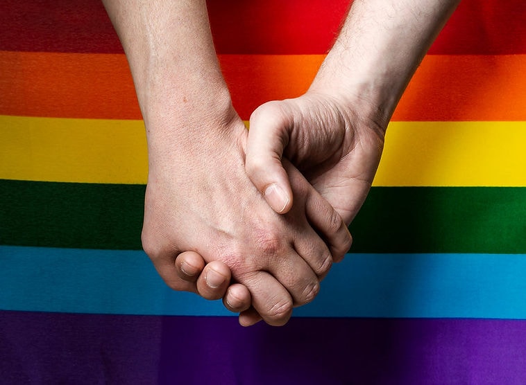 holding-hands-with-pride-flag.jpg