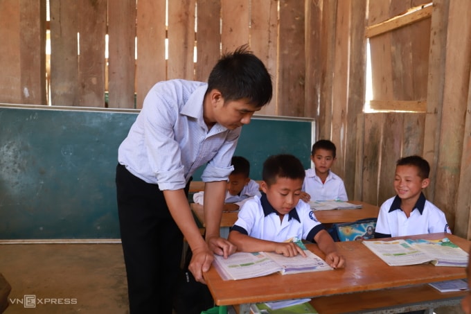 Thầy Hoàng Văn Ngọc (trái), 39 tuổi đang dạy học cho Lý Văn Hoàng, 10 tuổi, tháng 12/2025. Ảnh: Nga Thanh