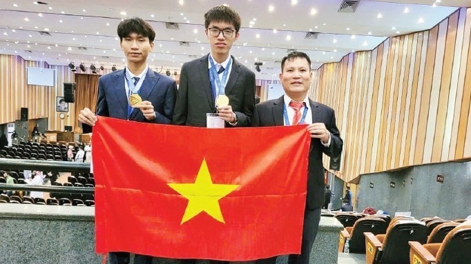 Nhà giáo Ưu tú Nguyễn Văn Đóa (ngoài cùng bên phải) cùng hai học sinh tại Olympic Vật lý quốc tế năm 2024.